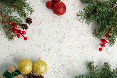 Noel dallarından yapılmış çerçeve, kızılcık, toplar ve grunge arkaplanda pullar