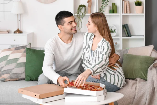Happy Young Couple Eating Tasty Pizza Home — Stock Photo, Image