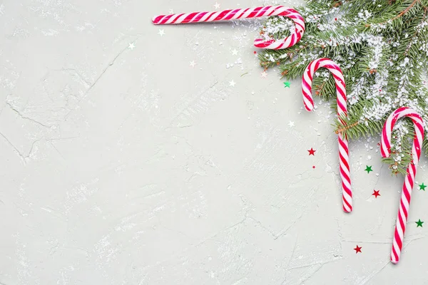 Composition Sweet Candy Canes Fir Branches Snow Light Background — Stock Photo, Image