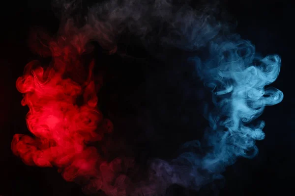Circle made of red and blue smoke on black background