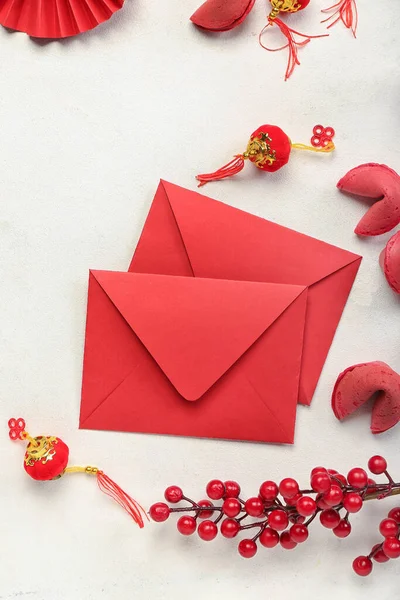 Red envelopes with fortune cookies and Chinese symbols on white background. New Year celebration