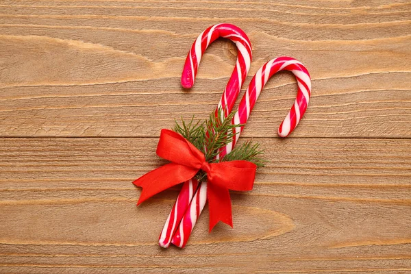 Sweet Candy Canes Red Bow Fir Branch Wooden Background — Stock Photo, Image