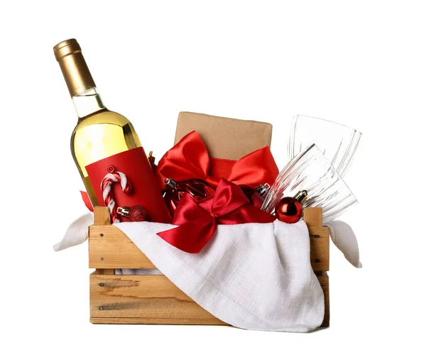 Wooden box with bottle of wine, glasses, Christmas balls and gift on white background