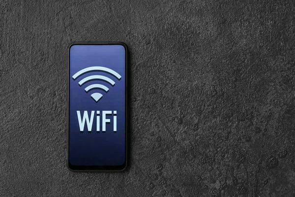 Mobile phone with WiFi symbol on dark background