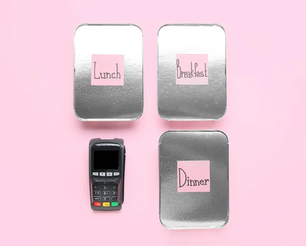 Payment terminal, takeaway boxes and sticky notes with words BREAKFAST, LUNCH, DINNER on color background