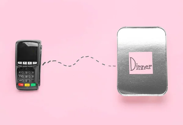 Payment terminal, takeaway box and sticky note with text DINNER on color background