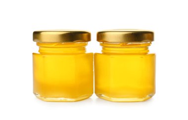 Beyaz arka planda izole edilmiş taze bal dolu kavanozlar