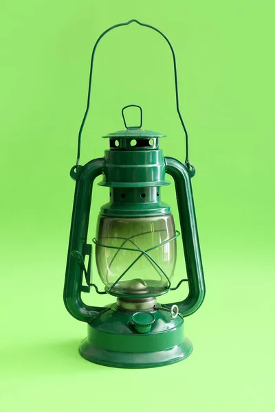 Metal lantern on green background