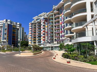Güneşli bir günde modern binalarla şehir caddesi manzarası