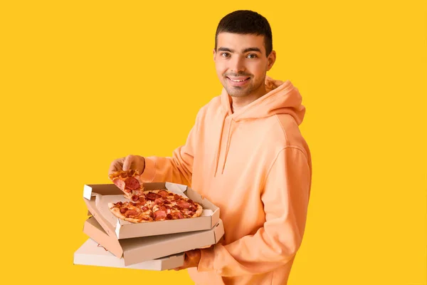 Handsome Young Man Holding Boxes Fresh Pizza Yellow Background — Stock Photo, Image