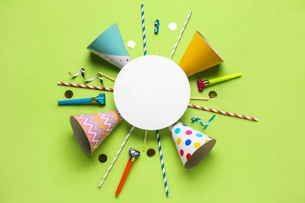 Blank card with party hats, confetti, straws and whistles on green background