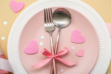 Sevgililer Günü için bej arka planda pembeler ve kurdeleler, yakın plan.