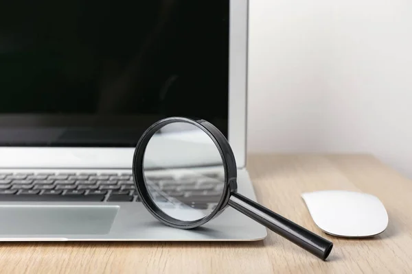 Modern Laptop Computer Mouse Magnifier Wooden Table White Wall Closeup — Stock Photo, Image