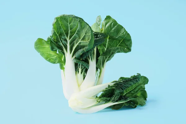 Fresh pak choi cabbages on color background