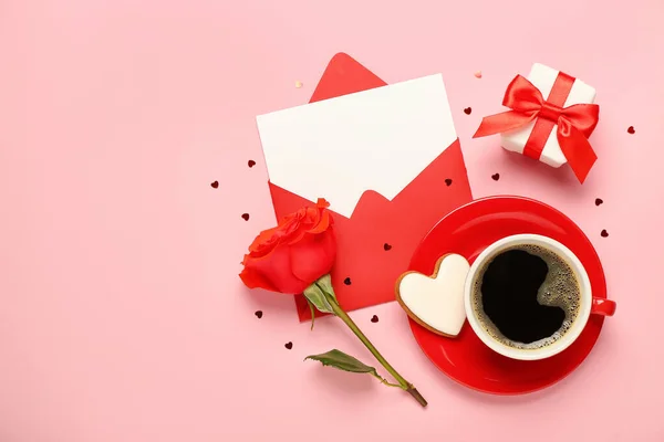 Blank letter with rose, gift and cup of coffee on pink background. Valentine's Day celebration
