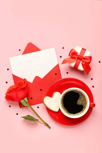 Blank letter with rose, gift and cup of coffee on pink background. Valentine\'s Day celebration