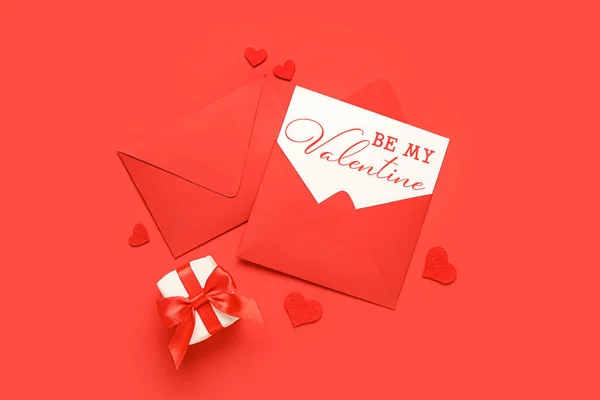 Envelopes, card for Valentine\'s Day and gift on red background