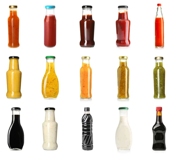 Collection of tasty sauces in bottles on white background
