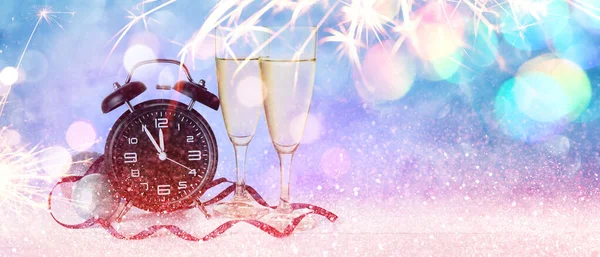 Beautiful New Year banner with alarm clock, champagne and decor