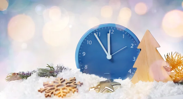 Clock, decor and snow on light background. Christmas countdown concept