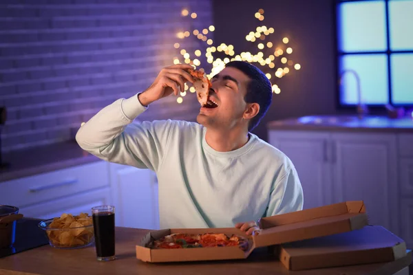 Young Man Eating Tasty Pizza Kitchen Night — Stock Photo, Image