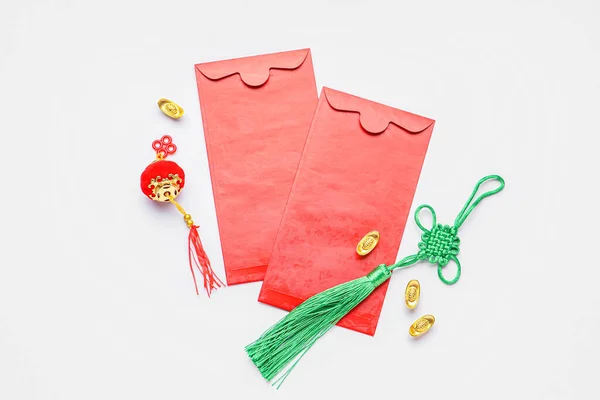 Red envelopes and Chinese symbols on white background. New Year celebration