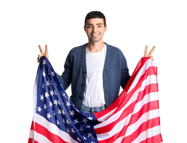 Young man with USA flag showing victory gesture on white background