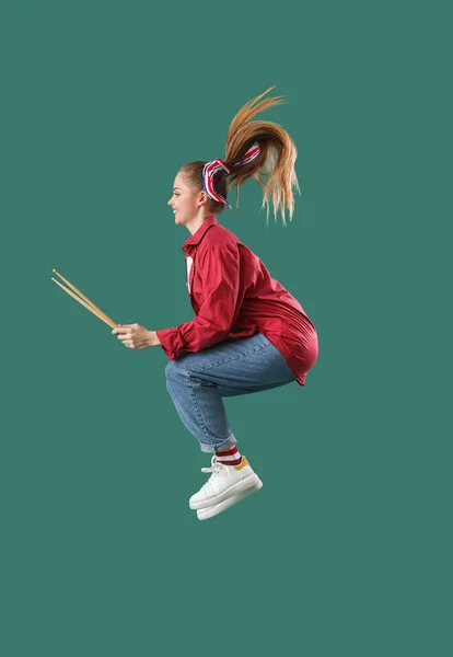 Young Woman Drumsticks Jumping Green Background — Stock Photo, Image