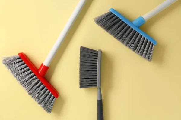 Cleaning brooms and brush on color background