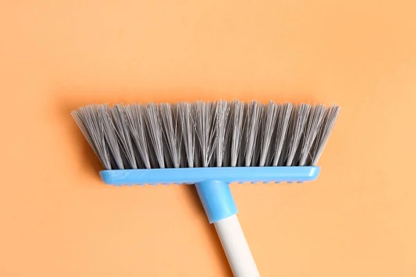 Cleaning broom on color background, closeup