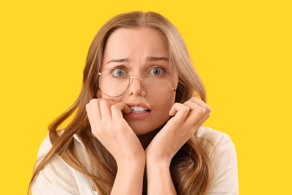 Young Woman Eyeglasses Biting Nails Yellow Background Closeup — Stock Photo, Image