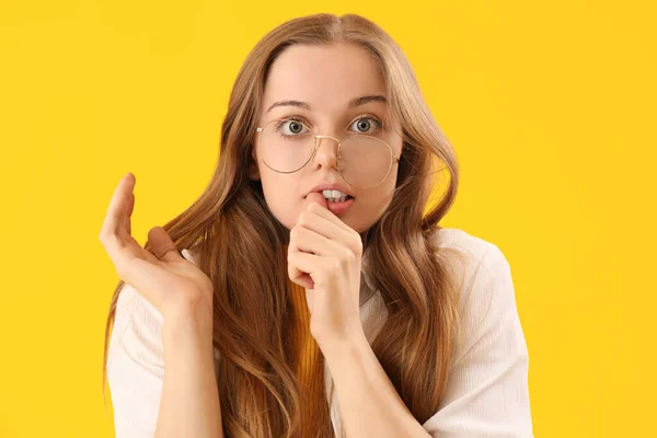 Young Woman Eyeglasses Biting Nails Yellow Background Closeup — Stock Photo, Image