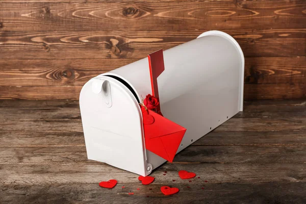Mailbox with letter, rose and hearts on wooden background. Valentine\'s Day celebration