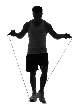 Beyaz arka planda ip atlayan genç adamın silueti.