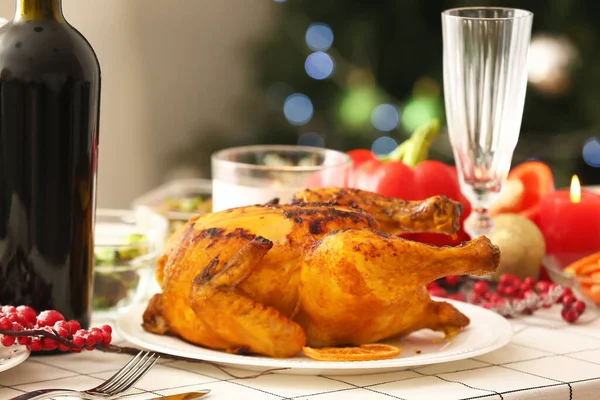 Christmas table setting with tasty chicken in dining room, closeup