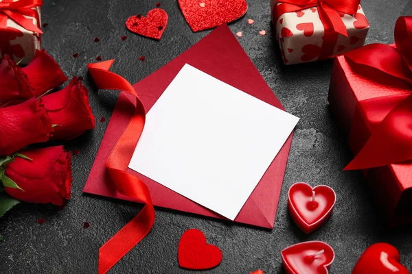 Blank letter with roses, gifts and hearts on dark background. Valentine\'s Day celebration