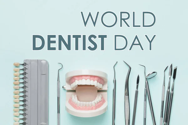 Card for World Dentist\'s Day with different tools on light blue background