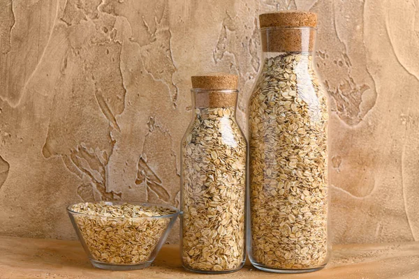 Bottles Bowl Raw Oatmeal Color Table — Stock Photo, Image