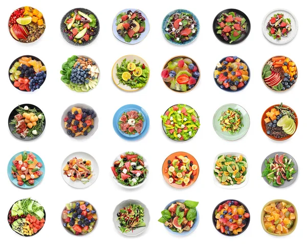 Collection of plates with healthy salads on white background
