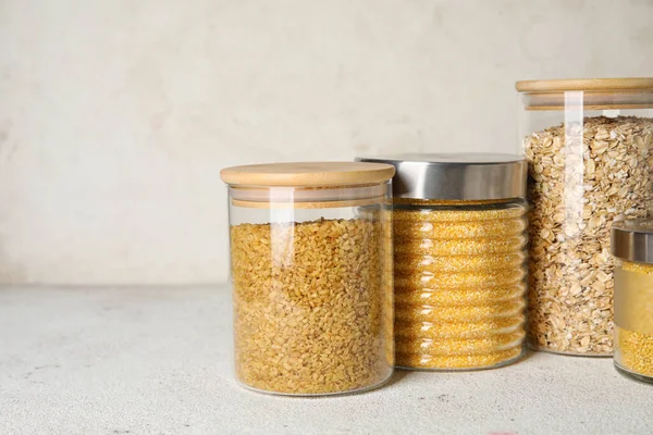 Glass Jars Different Cereals Light Background — Stock Photo, Image