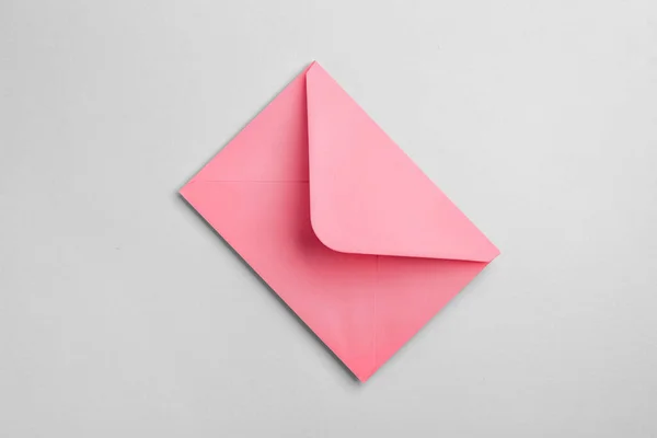 グレーの背景にピンクの封筒 — ストック写真