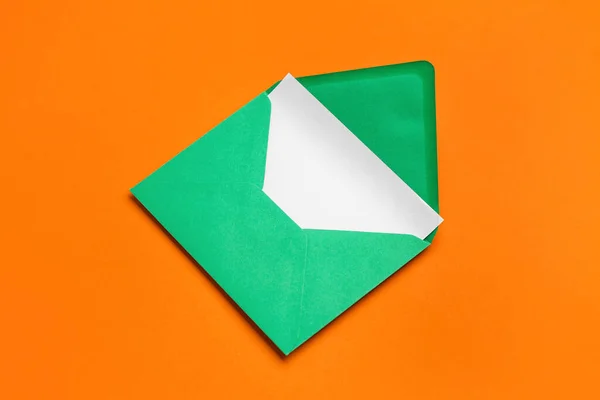 Green envelope with card on color background