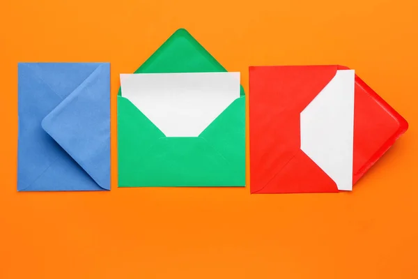 Different envelopes with cards on color background