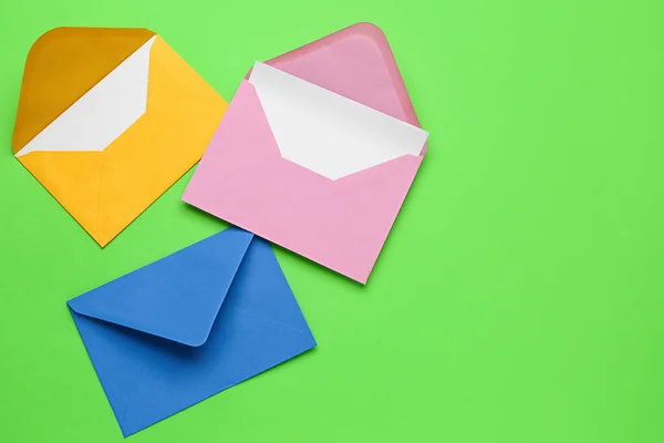 Paper envelopes with cards on green background