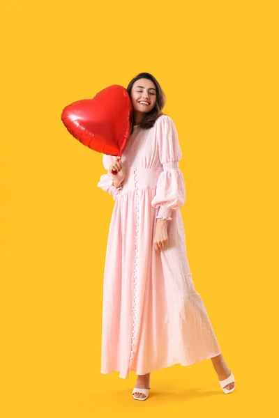 Young Woman Heart Shaped Balloon Yellow Background Valentine Day Celebration — Stock Photo, Image