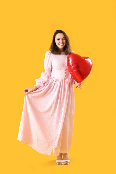 Young Woman Heart Shaped Balloon Yellow Background Valentine Day Celebration — Stock Photo, Image