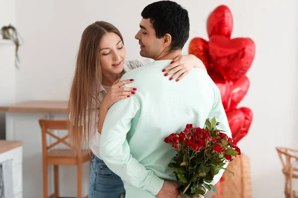 Young Man Red Roses His Girlfriend Kitchen Valentine Day — Stock Photo, Image