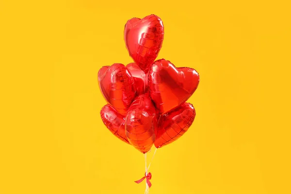 Heart-shaped balloons for Valentine\'s Day on yellow background