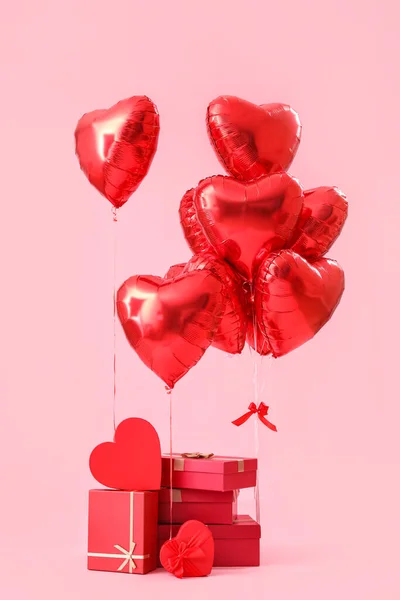 Gifts with heart-shaped balloons for Valentine's Day on pink background
