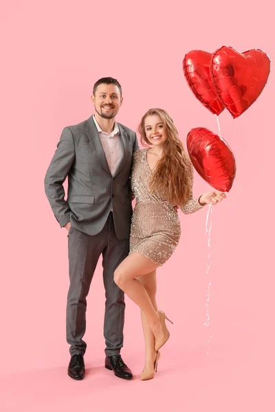 Happy Young Couple Heart Shaped Balloons Pink Background Valentine Day — Stock Photo, Image